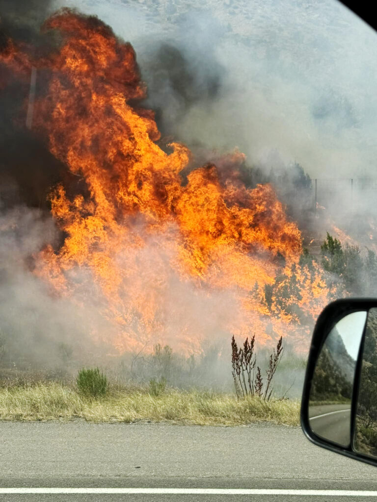 A brush fire burns along Interstate 70 in-between Rulison and West Rifle.