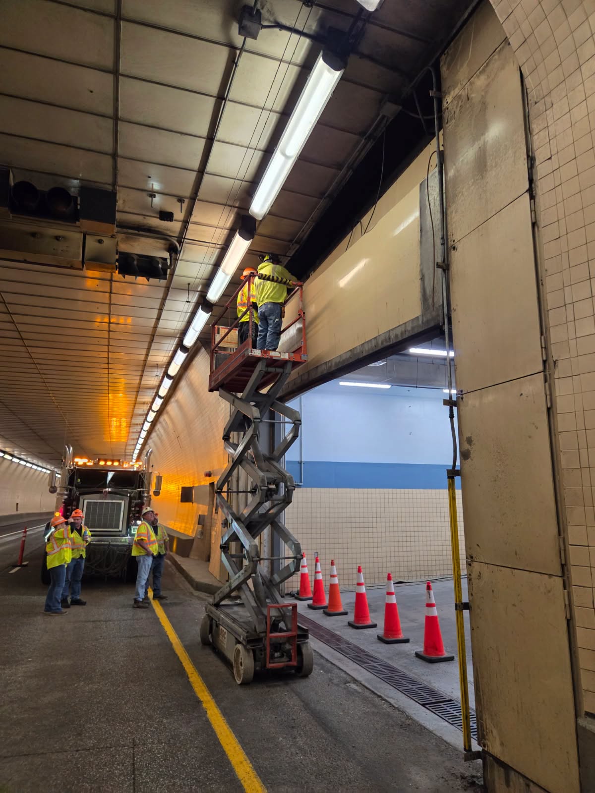 workers in closed lane of hanging lake tunnel on I70